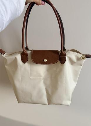 Жіноча сумка longchamp le pliage молочного кольору
