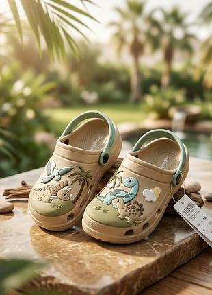 Дитячі сабо crocs бежеві з динозаврами