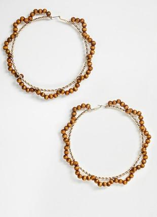 🌳 великі сережки-кільця з опліткою з намистин натурального дерева від asos оригінал