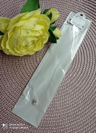 Чокер с красивым кристаллом овальной формы в оправе под золото