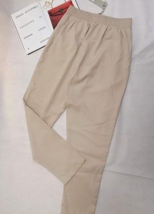Бежевые брюки на завязках с карманами2 фото