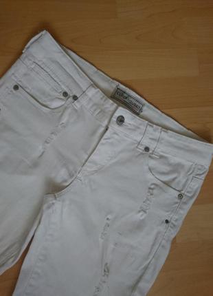 Белоснежные джинсы с дырками3 фото
