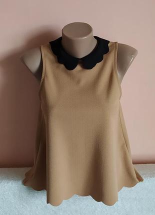 Як нова!модна блуза з фігурним низом та комірцем, вказано р.10.