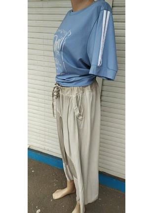 Итальянская коттоновая юбка с переходами ткани и карманами с блестящим дизайном3 фото