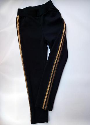 Чорні легінси з золотистими смугами d-zine р. 104-110