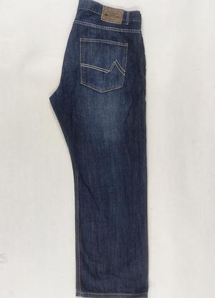 Фірмові джинси темно-синього кольору.6 фото