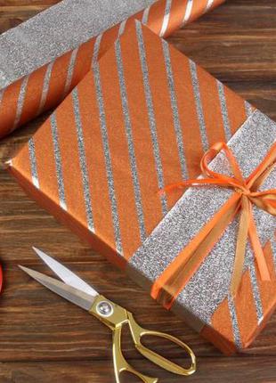 Папір пакувальна подарункова в смужку оранжево-срібляста 70см*50 см (20 аркушів)1 фото