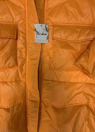 Женская пухова оранжевая куртка2 фото