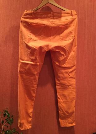 Стильные оранжевые штанишки с молниями по бокам2 фото