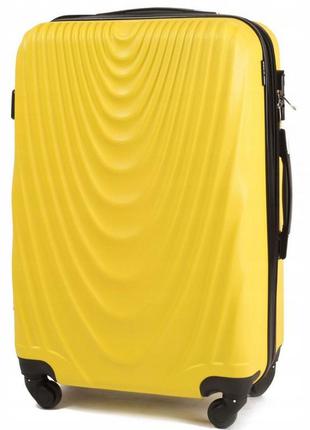 Пластикова велика дорожня валіза жовтого кольору на колесах wings 304  розмір l (великий) полікарбонат