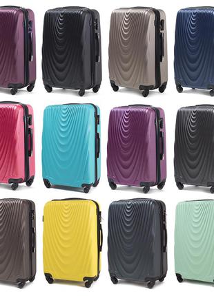 Пластикова велика дорожня валіза рожевого кольору на колесах wings 304  розмір l (великий) полікарбонат3 фото