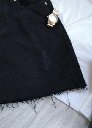 Крутая плотная черная джинсовая юбка с необработанным низом и фабричными рваностями.2 фото
