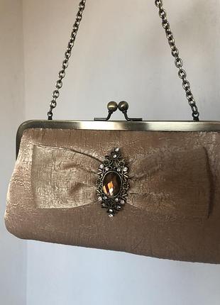 Красива театральная сумочка с акцентной брошью