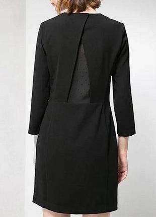 Черное короткое платье с длинными рукавами и вставки из сетки на спинке со стразами1 фото