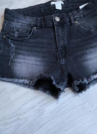 Серые джинсовые шорты с необработанным низом и фабричными потертостями.5 фото