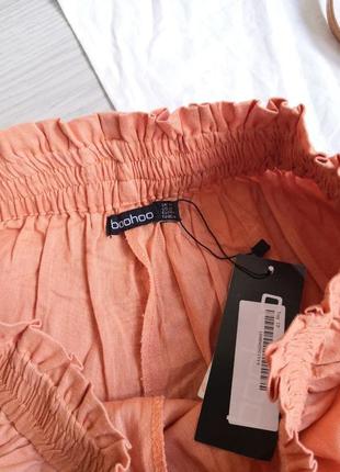 Оранжевые легкие шорты на резинке с кружевом5 фото