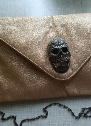 Золотиста сумка-клатч з черепом