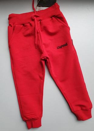 Червоні спортивні штани на резинці з карманами знизу на манжетах1 фото