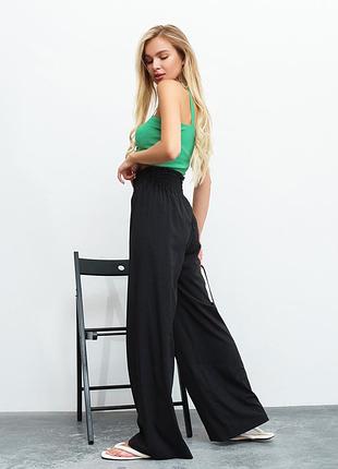 Чорні штани палаццо з рюшами