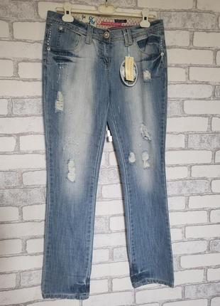 Светлые тонкие рваные джинсы1 фото