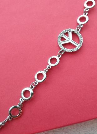 Срібний металевий браслет з підвіскою світ камінці peace круглий2 фото