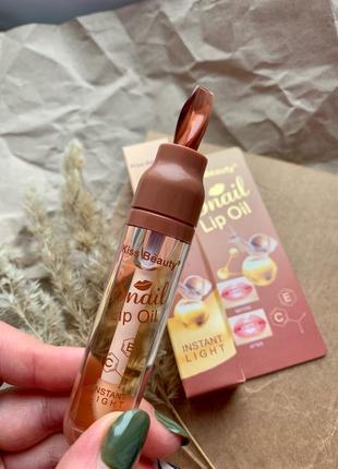 Блеск для увеличения оъёма губ snail lip oil1 фото