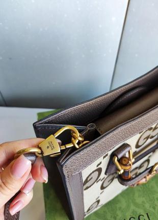 Шикарна брендова коричнева сумка із круглими ручками6 фото
