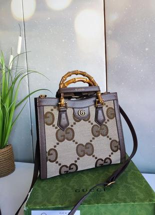 Шикарна брендова коричнева сумка із круглими ручками1 фото