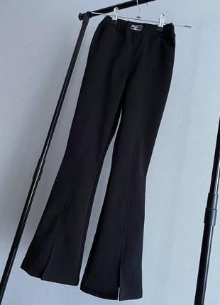 Стильні теплі брюки кльош на флісі від коліна з розрізами 128-158 см штаны клеш с разрезами на флисе