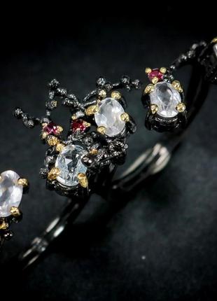 Срібне кільце ручної роботи на два пальці з білими топазами та гранатами родолітами, безрозмірне