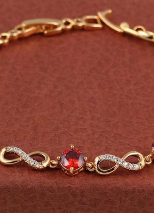 Браслет xuping jewelry восьмерки с тремя круглыми красными камнями по центру 17 см  8 мм золотистый