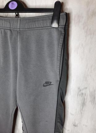 Крутые оригинальные мужские серые спортивные штаны nike nsw2 фото