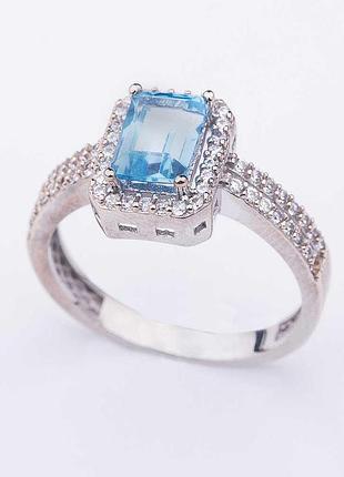 Золоте кільце з блакитним топазом і фіанітами 
к04633