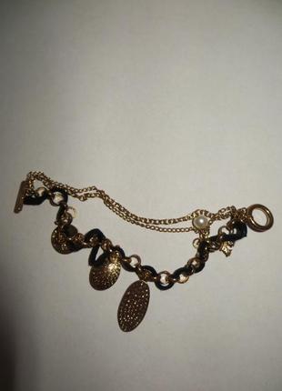 Женский браслет под золото с тканевым шнурком.2 фото
