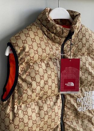 Чоловіча коричнева жилетка the north face gucci2 фото