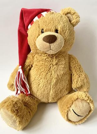 Мягкая игрушка большой плюшевый медведь в новогодней шапке2 фото