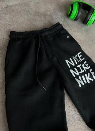 Чоловічі теплі чорні спортивні штани nike7 фото