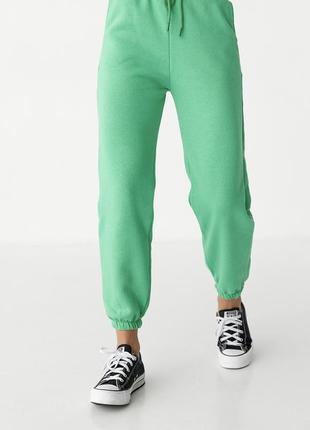 Утеплені штани зелені жіночі, яскраві штани1 фото