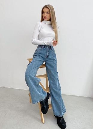 Расклешенные джинсы с рваной отделкой4 фото