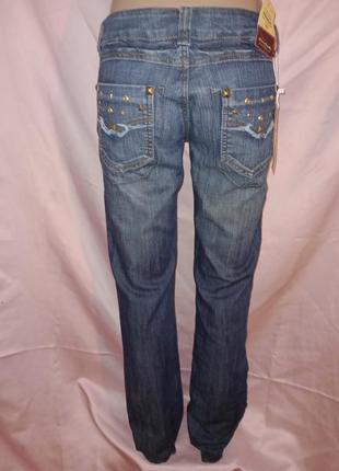 Нові жіночі джинси із заклепками кльош розмір 29. chuand tian nu8 фото