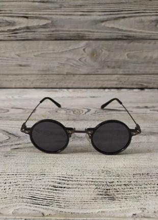 Сонцезахисні окуляри круглі, чорні в пластиковій та металевій оправі3 фото