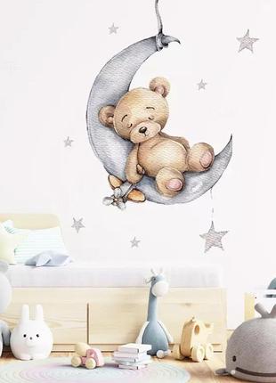 Вінілова наклейка на стіну для дитячої кімнати "медведик тедді на місяці з зірками" - 84*64см1 фото