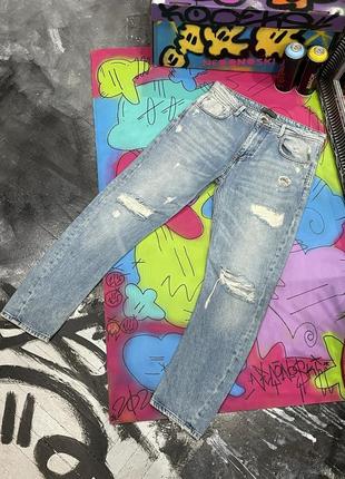 Плотные джинсы с фабричными потертостями и дырками