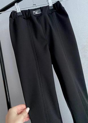 Чорні штани клеш з розрізами для дівчинки2 фото