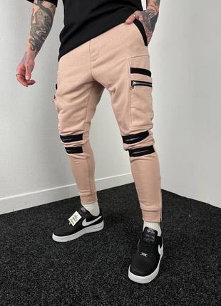 Стильовые спортивные штаны с замками качественные зауженные оригинальные1 фото