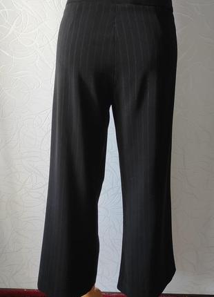 Черные брюки, клеш от бедра, размер 543 фото