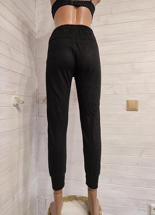 Теплые спортивные штаны на манжетах с кармашками на 9-14  лет7 фото