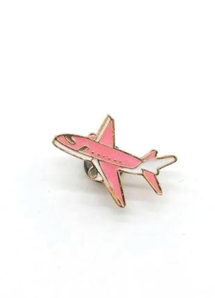 Значок / пін металевий літак рожевого кольору з білими вставками