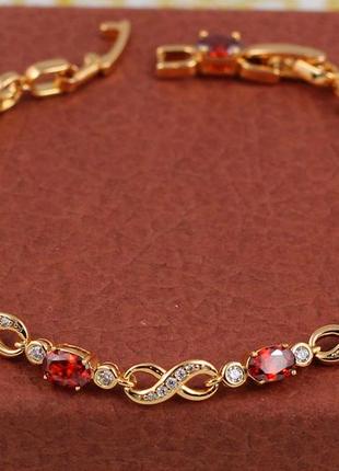Браслет xuping jewelry вісімки з червоними овальними каменями по всій довжині 17 см 6 мм золотистий