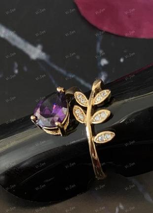 Кольцо веточка с фиолетовым и белым камнем с фиолетовым и белым камнем. золотого цвета.